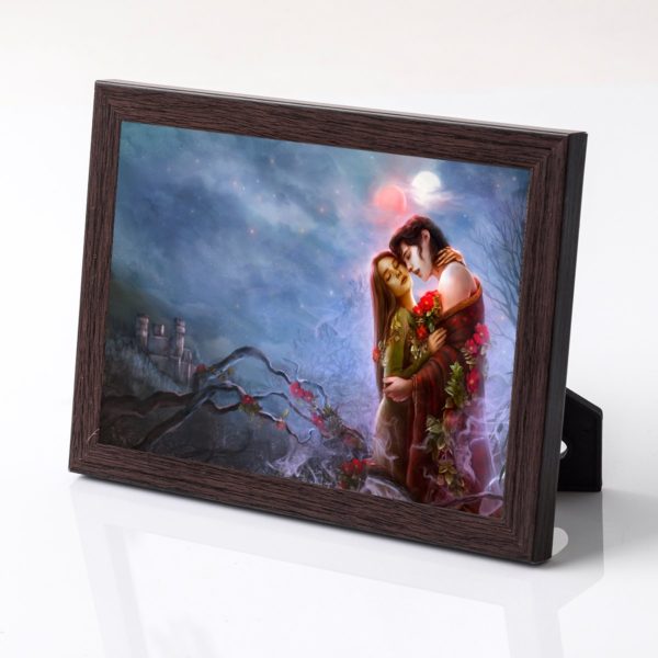 Blood Mercy print in a dark wooden frame. Artwork shows Lio and Cassia embracining under the moons, entwined with red roses.
